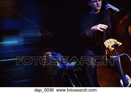 Young man playing the stand-up bass View Large Photo Image Stock Photograph - Young man playing the stand-up bass. Fotosearch