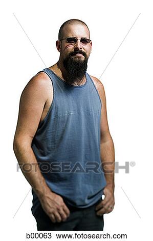 Stock Image - Young man standing with hands in his pockets. Fotosearch