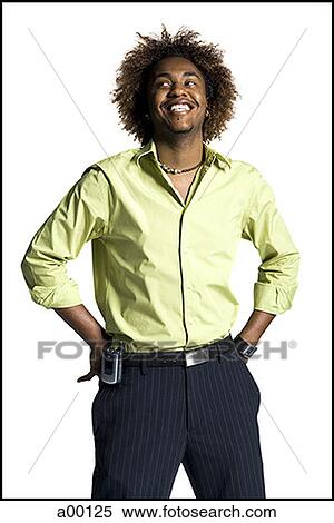 Young man standing with his hands on his hips View Large Photo Image Stock Photography - Young man standing with his hands on his hips. Fotosearch