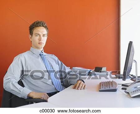 Young man stretching his legs and holding a blank sign View Large Photo Image Stock Image - Young man stretching his legs and holding a blank sign. Fotosearch