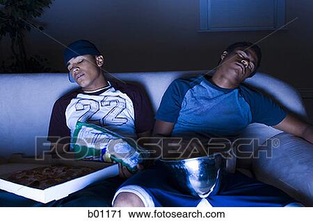 Young men asleep in front of the TV View Large Photo Image Stock Image - Young men asleep in front of the TV. Fotosearch