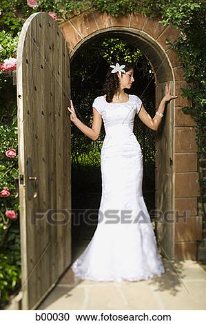 Young modern bride standing at the doorway View Large Photo Image Stock Image - Young modern bride standing at the doorway. Fotosearch