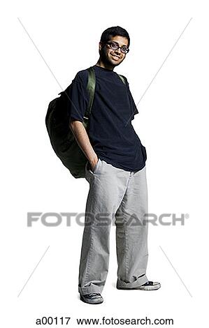 Young studious man standing with hands in his pockets View Large Photo Image Stock Photo - Young studious man standing with hands in his pockets. Fotosearch