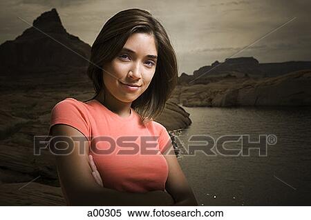 Young woman at the shore of a lake View Large Photo Image Stock Photography - Young woman at the shore of a lake. Fotosearch