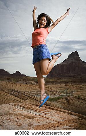 Young woman jumping outdoors View Large Photo Image Stock Image - Young woman jumping outdoors. Fotosearch