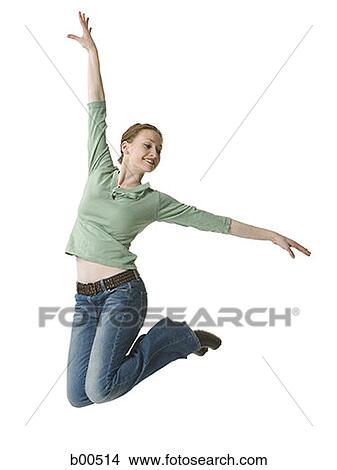 Young woman jumping with her hand raised View Large Photo Image Picture - Young woman jumping with her hand raised. Fotosearch