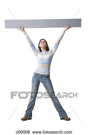 Young woman lifting up a blank sign View Large Photo Image Stock Photo - Young woman lifting up a blank sign. Fotosearch