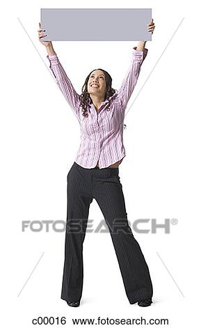 Stock Photograph - Young woman lifting up a blank sign. Fotosearch