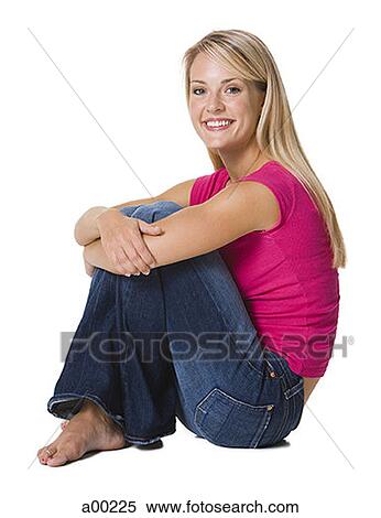 Stock Photography - Young woman sitting and smiling. Fotosearch