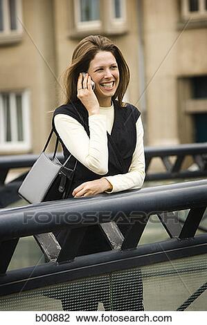 Stock Image - Young woman talking on a mobile phone. Fotosearch