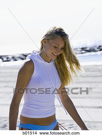 Young woman walking on the beach View Large Photo Image Picture - Young woman walking on the beach. Fotosearch
