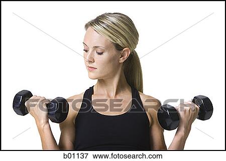 Young woman working out with dumbbells View Large Photo Image Stock Photo - Young woman working out with dumbbells. Fotosearch
