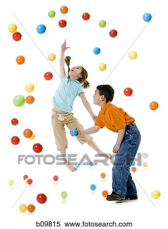 A boy and a girl playing with colorful balls View Large Photo Image Stock Photography - A boy and a girl playing with colorful balls. Fotosearch