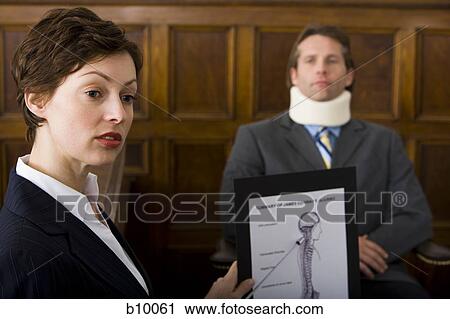 A female lawyer pointing at evidence in front of a victim in a courtroom View Large Photo Image Stock Image - A female lawyer pointing at evidence in front of a victim in a courtroom. Fotosearch