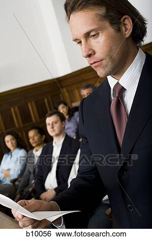 A juror standing in a jury box and reading the verdict View Large Photo Image Stock Photograph - A juror standing in a jury box and reading the verdict. Fotosearch
