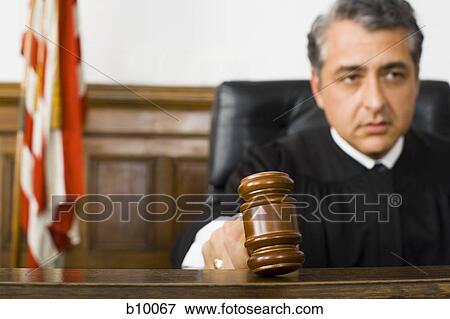 A male judge hitting a gavel on the bench View Large Photo Image Stock Photo - A male judge hitting a gavel on the bench. Fotosearch