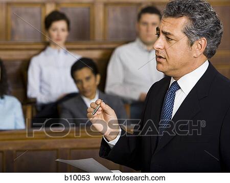 A male lawyer talking in a courtroom View Large Photo Image Stock Image - A male lawyer talking in a courtroom. Fotosearch