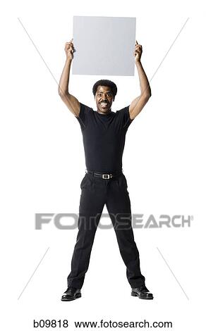 A man smiling and holding a blank sign View Large Photo Image Stock Photo - A man smiling and holding a blank sign. Fotosearch