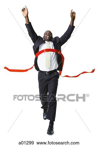 Stock Photo - A running businessman takes first place as he crosses the finish line. Fotosearch