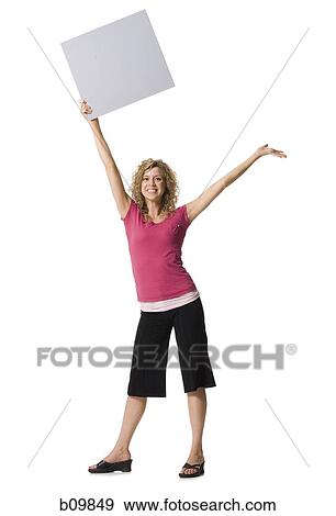 A young woman holding a blank sign View Large Photo Image Stock Photo - A young woman holding a blank sign. Fotosearch