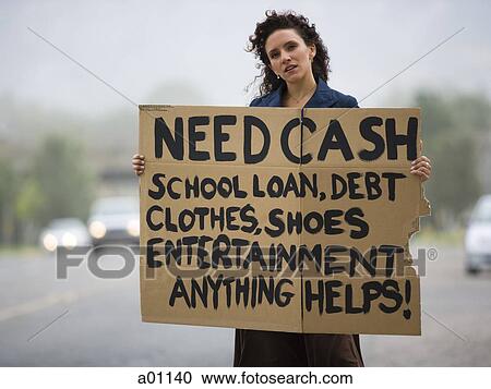 A young woman holding a help-needed sign View Large Photo Image Stock Image - A young woman holding a help-needed sign. Fotosearch