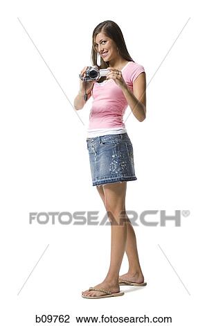 A young woman holding a home video camera View Large Photo Image Stock Image - A young woman holding a home video camera. Fotosearch