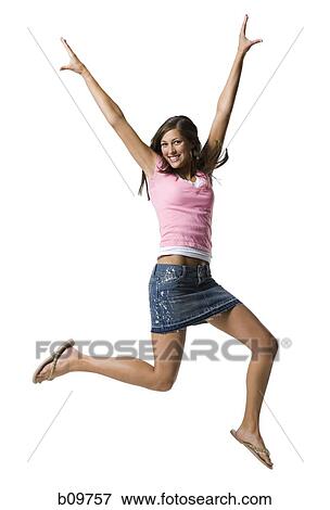 A young woman jumping and smiling View Large Photo Image Stock Photo - A young woman jumping and smiling. Fotosearch