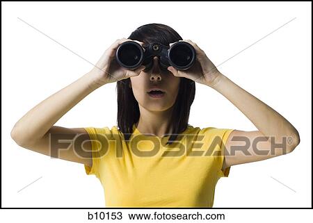 Stock Image - A young woman looking through a pair of binoculars. Fotosearch