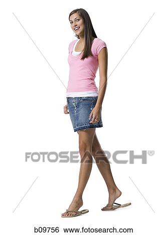 Stock Photograph - A young woman smiling and walking. Fotosearch