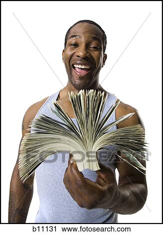 Stock Image - African American holding a pile of dollar bills. Fotosearch