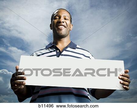 African American man holding a blank sign View Large Photo Image Stock Photograph - African American man holding a blank sign. Fotosearch
