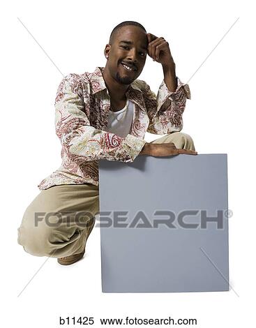 African American man holding a blank sign View Large Photo Image Stock Photography - African American man holding a blank sign. Fotosearch