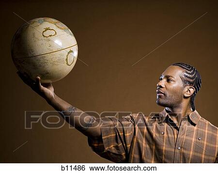 African American man holding a globe View Large Photo Image Stock Photograph - African American man holding a globe. Fotosearch