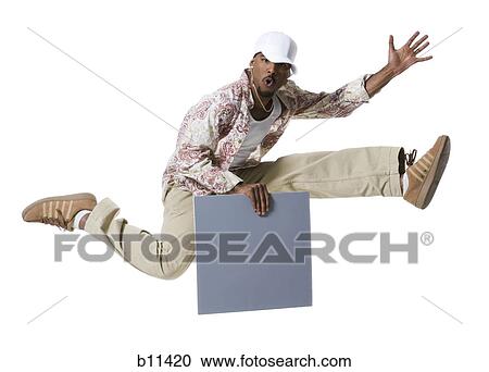African American man jumping and holding a blank sign View Large Photo Image Stock Image - African American man jumping and holding a blank sign. Fotosearch