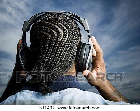 African American man listening to music on headphones View Large Photo Image Stock Image - African American man listening to music on headphones. Fotosearch