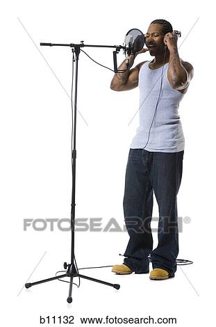 Stock Image - African American man singing into microphone. Fotosearch