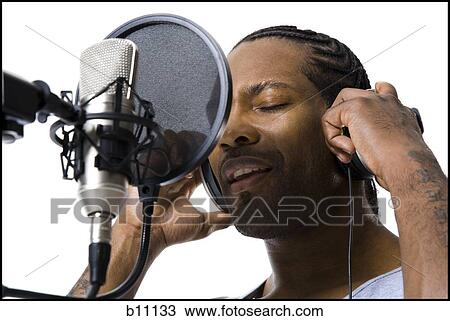 Stock Image - African American man singing into microphone. Fotosearch