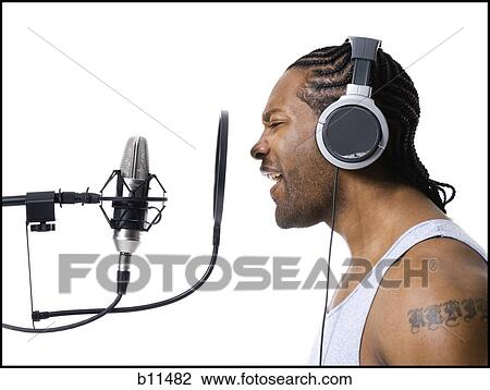 Stock Image - African American man singing into microphone. Fotosearch