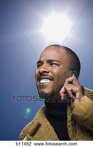 African American man smiling and talking on cell phone View Large Photo Image Stock Image - African American man smiling and talking on cell phone. Fotosearch