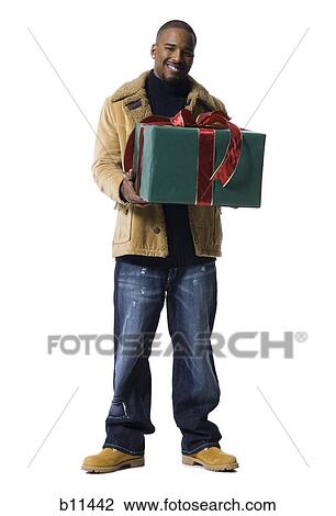 African American man with Christmas gift View Large Photo Image Stock Image - African American man with Christmas gift. Fotosearch