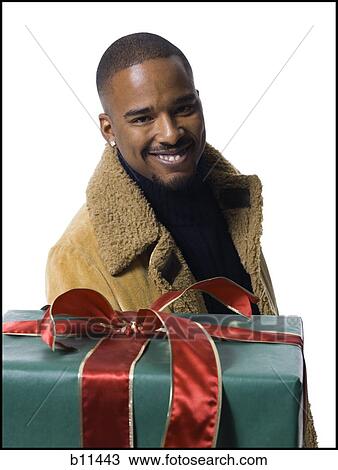 African American man with Christmas gift View Large Photo Image Stock Image - African American man with Christmas gift. Fotosearch