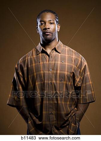 Stock Image - African American man with hands in pockets. Fotosearch