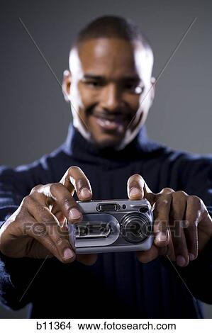 African American taking picture with digital camera View Large Photo Image Picture - African American taking picture with digital camera. Fotosearch