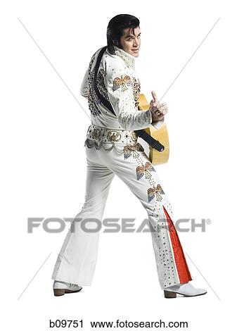 An Elvis impersonator holding a guitar View Large Photo Image Stock Image - An Elvis impersonator holding a guitar. Fotosearch