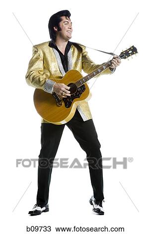 An Elvis impersonator playing the guitar View Large Photo Image Stock Image - An Elvis impersonator playing the guitar. Fotosearch