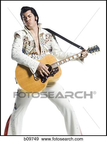An Elvis impersonator playing the guitar View Large Photo Image Stock Photo - An Elvis impersonator playing the guitar. Fotosearch