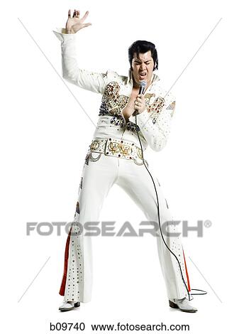 An Elvis impersonator singing into a microphone View Large Photo Image Stock Image - An Elvis impersonator singing into a microphone. Fotosearch