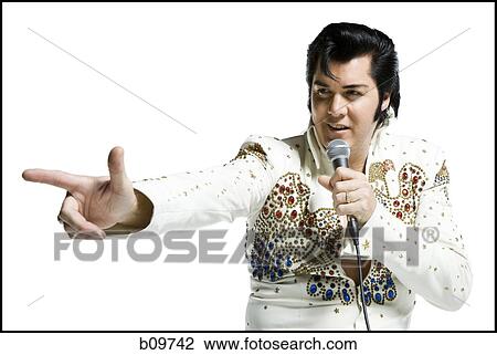 An Elvis impersonator singing into a microphone View Large Photo Image Stock Image - An Elvis impersonator singing into a microphone. Fotosearch