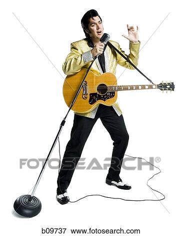 An Elvis impersonator singing into a microphone View Large Photo Image Stock Photo - An Elvis impersonator singing into a microphone. Fotosearch