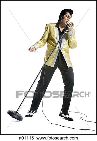 Stock Photography - An Elvis impersonator singing into a microphone. Fotosearch
